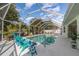 Screened-in pool area with lounge chairs, providing a private and relaxing outdoor space at 23488 Almond Ave, Port Charlotte, FL 33954