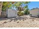 Backyard with a storage shed and low-maintenance gravel landscaping at 2440 Ednor St, Port Charlotte, FL 33952