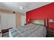 Bedroom with a large bed, bold accent wall, and two night stands at 2440 Ednor St, Port Charlotte, FL 33952