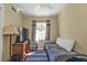 Charming bedroom with a comfortable bed, natural light, and laminate floors at 2440 Ednor St, Port Charlotte, FL 33952