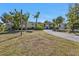 Single-story home with tidy lawn and shrubbery, showing an inviting, well-kept landscape at 2440 Ednor St, Port Charlotte, FL 33952