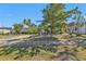 Lovely exterior view of the house, featuring mature trees and a well-maintained front yard and driveway at 2440 Ednor St, Port Charlotte, FL 33952