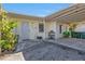 Inviting front entrance with a covered carport, small garden accents, and the house number clearly displayed at 2440 Ednor St, Port Charlotte, FL 33952
