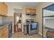 View of stainless steel oven and upper cabinets in the kitchen with tile floor at 2440 Ednor St, Port Charlotte, FL 33952