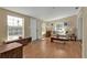 Inviting living room with wood floors, light-filled with natural light, offering a relaxing ambiance at 2440 Ednor St, Port Charlotte, FL 33952