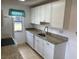 Well lit kitchen featuring granite countertops and modern white cabinetry at 25068 Harborview Rd # 4B, Punta Gorda, FL 33980