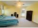 Bedroom with neutral carpet, ceiling fan, and large windows offering ample natural light at 26102 Ancuda Dr, Punta Gorda, FL 33983