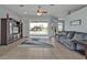 Bright living room with tile floors, ceiling fan, comfortable seating, and sliding glass doors to screened pool at 26102 Ancuda Dr, Punta Gorda, FL 33983