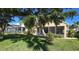 Lush backyard featuring a covered patio and mature trees, offering a serene outdoor space at 26287 Stillwater Cir, Punta Gorda, FL 33955