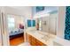 Bathroom featuring double sinks, a large mirror, and access to the bedroom at 26287 Stillwater Cir, Punta Gorda, FL 33955