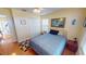 Comfortable bedroom featuring wood floors, a ceiling fan, and a charming window at 26287 Stillwater Cir, Punta Gorda, FL 33955