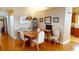 Bright dining area showcasing wood floors, tasteful decor, and ample natural light at 26287 Stillwater Cir, Punta Gorda, FL 33955