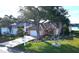 Beautiful home with mature landscaping, a tile roof, and a paver driveway near a lake at 26287 Stillwater Cir, Punta Gorda, FL 33955