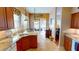 Bright kitchen featuring granite countertops, wood cabinetry, and lake views at 26287 Stillwater Cir, Punta Gorda, FL 33955