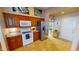 Functional kitchen with white appliances, tile floors, and ample cabinet space at 26287 Stillwater Cir, Punta Gorda, FL 33955