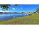 Expansive lake view with a tree in foreground with lawn at 26287 Stillwater Cir, Punta Gorda, FL 33955