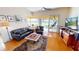 Cozy living room with sliding glass doors leading to an outdoor area and serene lake views at 26287 Stillwater Cir, Punta Gorda, FL 33955