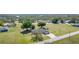Aerial view of a home on a large lot with mature trees and a road in front of the house at 31093 N Bend St, Punta Gorda, FL 33982