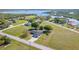 Aerial view of a home on a large lot near the river with mature trees in a green area at 31093 N Bend St, Punta Gorda, FL 33982