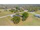 Aerial view of home with fenced yard and mature trees with additional land across the street at 31093 N Bend St, Punta Gorda, FL 33982
