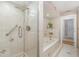 Bright bathroom features a glass-enclosed shower, and tiled whirlpool tub at 31093 N Bend St, Punta Gorda, FL 33982