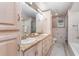 Bright bathroom features double vanity with granite counters, and tiled shower and tub at 31093 N Bend St, Punta Gorda, FL 33982