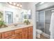 Bright bathroom with a shower and vanity with stone counter and wood cabinets at 31093 N Bend St, Punta Gorda, FL 33982