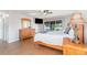 A spacious bedroom with a sliding glass door, dresser and wall-mounted television at 31093 N Bend St, Punta Gorda, FL 33982