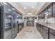A kitchen featuring dark wood cabinetry, granite countertops, stainless steel appliances, and a breakfast bar with seating at 31093 N Bend St, Punta Gorda, FL 33982