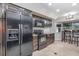 Open kitchen featuring dark wood cabinetry, granite countertops, stainless steel appliances and eat in breakfast nook at 31093 N Bend St, Punta Gorda, FL 33982