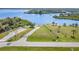 A vacant lot surrounded by water and trees featuring a long driveway and a small boat ramp at 31093 N Bend St, Punta Gorda, FL 33982