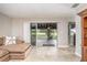 Living room featuring tile flooring, neutral walls, and sliding doors to the outdoor patio at 31093 N Bend St, Punta Gorda, FL 33982