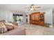 Cozy living room with a large sectional couch, tiled floors, ceiling fan, and sliding glass doors to the patio at 31093 N Bend St, Punta Gorda, FL 33982