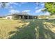 Back of house featuring a very large, screened in porch with views of a big lawn at 31093 N Bend St, Punta Gorda, FL 33982