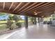 Wide screened in porch with ceiling fans and tiled floor overlooking a green lawn at 31093 N Bend St, Punta Gorda, FL 33982