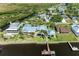 Aerial view of the waterfront home featuring a pool, dock, and outdoor living area at 3790 Peace River Dr, Punta Gorda, FL 33983