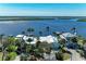 Stunning waterfront property featuring lush landscaping, private boat docks, and panoramic views of the tranquil bay at 3790 Peace River Dr, Punta Gorda, FL 33983