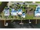 Aerial view of the property with a private dock, swimming pool, lush landscaping, and waterfront access at 3790 Peace River Dr, Punta Gorda, FL 33983