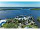Expansive aerial view showcases the stunning waterfront home with boat dock amidst lush landscaping and serene water views at 3790 Peace River Dr, Punta Gorda, FL 33983