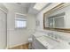 Bright bathroom with stylish mirror, a shower and a tiled floor at 3790 Peace River Dr, Punta Gorda, FL 33983