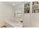 Relaxing bathroom with a soaking tub, built-in shelves, and natural light at 3790 Peace River Dr, Punta Gorda, FL 33983