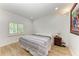 This simple bedroom offers a queen size bed and natural light from the window with shutters at 3790 Peace River Dr, Punta Gorda, FL 33983