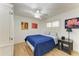 Cozy bedroom with wood floors, ceiling fan and window with shuttered blinds at 3790 Peace River Dr, Punta Gorda, FL 33983