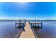 Private boat dock with a wooden walkway and deep water access to the bay at 3790 Peace River Dr, Punta Gorda, FL 33983