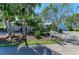 Beautiful home showcasing lush landscaping, mature trees, and a charming front yard at 3790 Peace River Dr, Punta Gorda, FL 33983