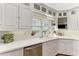 Bright kitchen with white cabinets, stainless steel appliances, and a window overlooking the outdoors at 3790 Peace River Dr, Punta Gorda, FL 33983