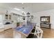 Bright kitchen features white cabinetry, stainless steel appliances, and a unique blue-tiled island with seating at 3790 Peace River Dr, Punta Gorda, FL 33983
