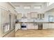 This stunning kitchen offers neutral cabinets, stainless steel appliances, and wood flooring at 3790 Peace River Dr, Punta Gorda, FL 33983