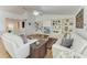 Comfortable living room featuring white sofas and a decorative built-in bookshelf at 3790 Peace River Dr, Punta Gorda, FL 33983