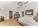 Bright main bedroom features vaulted ceiling, unique chandelier, and wood floors at 3790 Peace River Dr, Punta Gorda, FL 33983